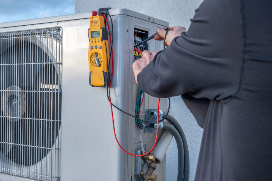 HVAC repair technician working on a Davis County home heating and cooling system