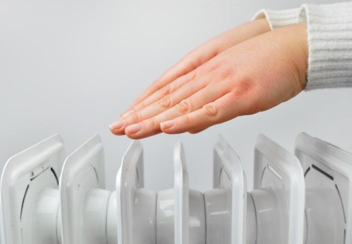 woman warming hands on heater kearns ut